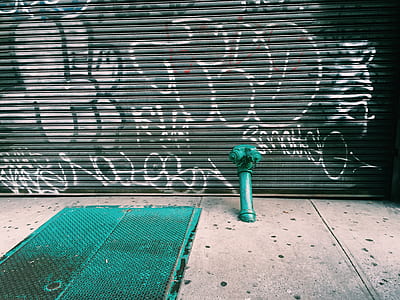 teal hydrant against graffiti wall thumbnail