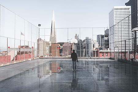 person in black jacket standing on top floor of building during daytime thumbnail