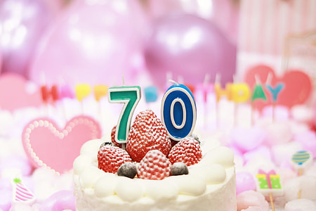 white and red Cake with strawberry on top 70th birthday celebration thumbnail