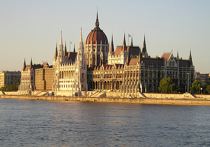 brown building near body of water thumbnail