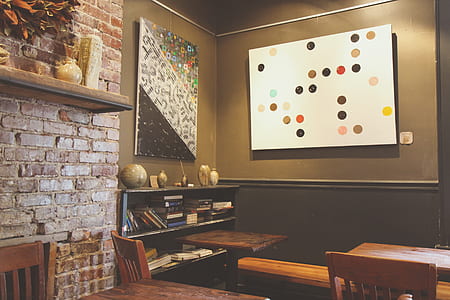 multicolored abstract painting near brown wooden tables thumbnail
