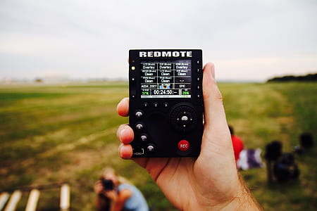 person holding black Redmote remote thumbnail
