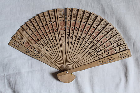 brown floral hand fan on white textile thumbnail