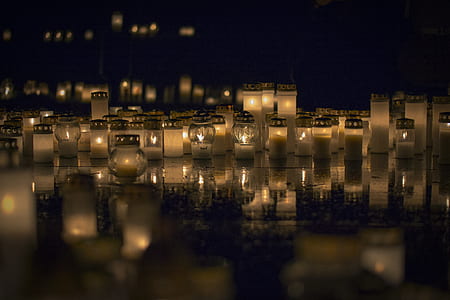 candle lights lighted on gray pavement thumbnail