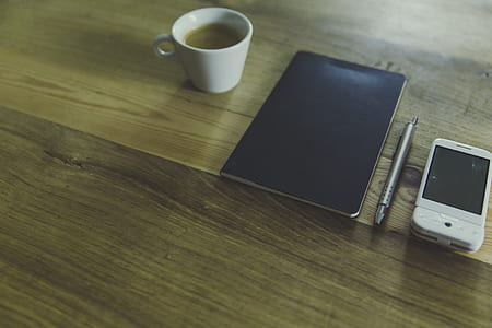 Black Table Computer Beside White Mug thumbnail