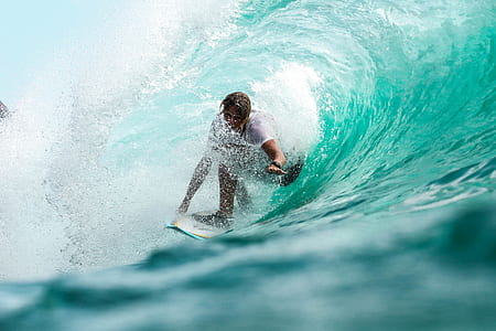 man riding on white surfboard and making tricks thumbnail