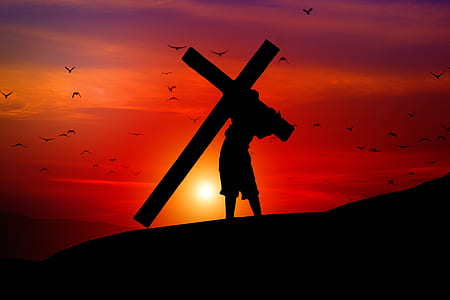 silhouette of person carrying cross thumbnail