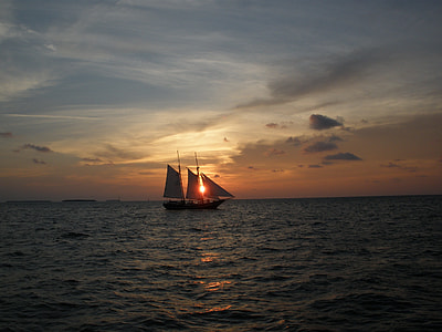 black sailboats on sea during sunset thumbnail