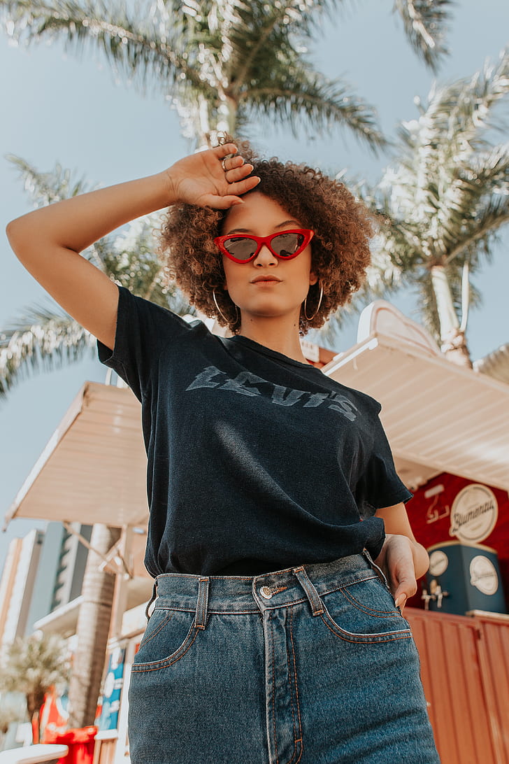 low-angle of woman in black shirt wearing sunglasses