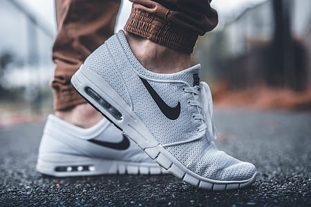 person wearing white Nike sneakers thumbnail