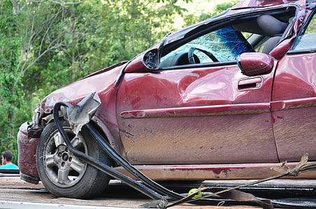 wreck red car near green tree during daytime thumbnail