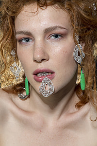 woman with drop earring on her mouth thumbnail