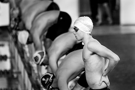 tilt shift lens photography of swimmer man thumbnail