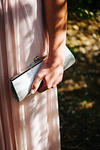 person holding long wallet thumbnail