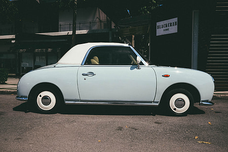 white coupe parked on street during daytime thumbnail