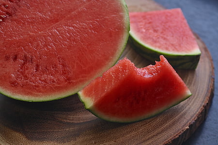 sliced watermelon on brown wooden surface thumbnail
