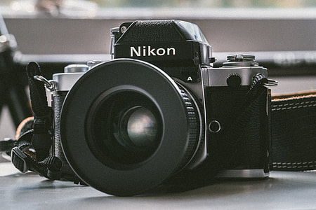 black Nikon DSLR camera thumbnail