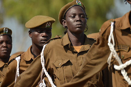 men wearing brown military uniform standing in line at daytime thumbnail