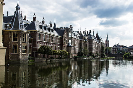 brown and gray houses near lake during daytime thumbnail