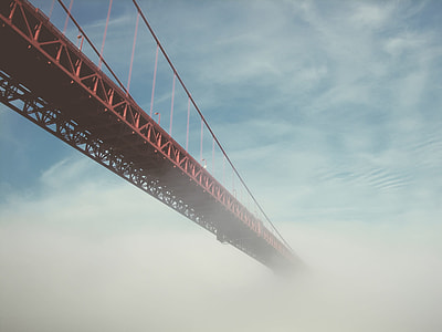 red steel bridge with white clouds photography thumbnail