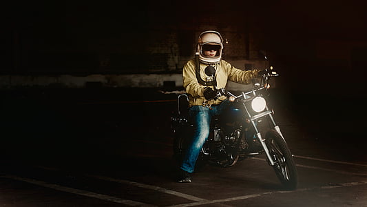 man in yellow jacket and blue jeans riding on black motorcycle thumbnail