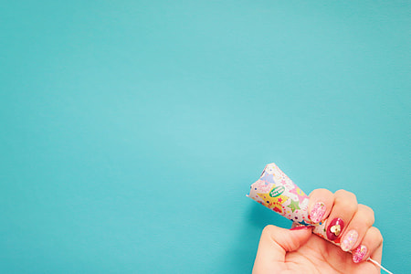 person holding multicolored cone thumbnail