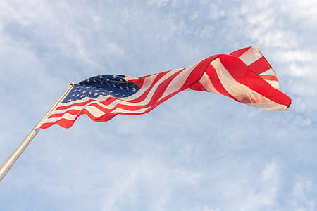 American flag under sunny sky thumbnail