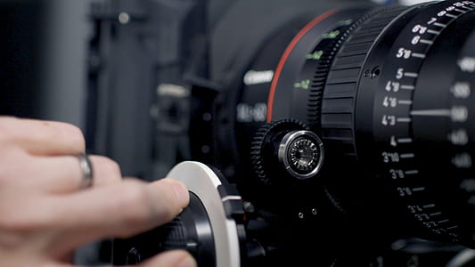 person adjusting camera lens thumbnail