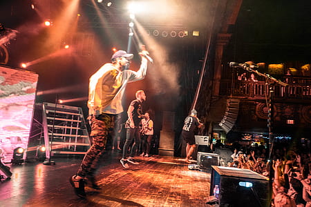 two man standing on stage in front of crowd thumbnail