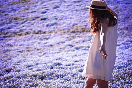 photo of woman wearing white clothes walking on purple flower field thumbnail