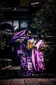 woman wearing purple dress under open umbrella photo thumbnail