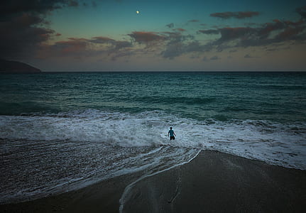 person on beach under gray skies thumbnail
