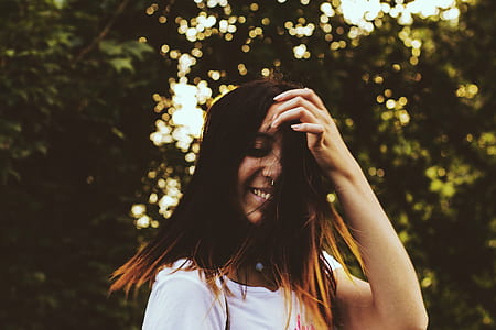 selective focus photography of woman near trees thumbnail