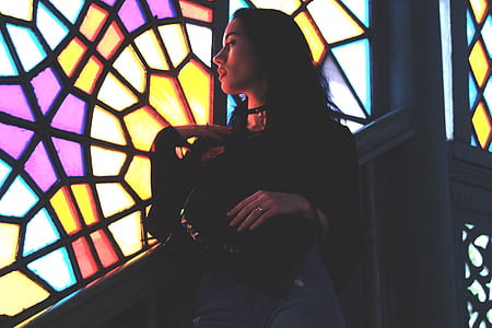 woman looking at multi-color glass window thumbnail