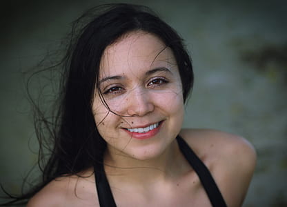 selective focus photography of smiling woman wearing black strap top thumbnail