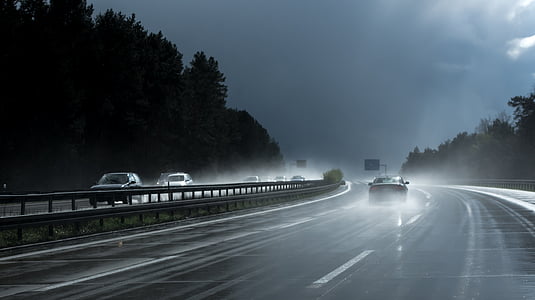 vehicles on highway with water sprinkling over the place thumbnail