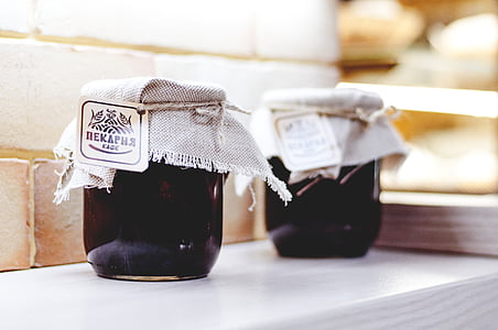two clear glass containers on white table thumbnail