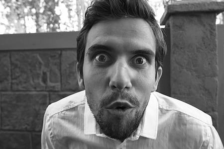 grayscale portrait photography of man in collared top thumbnail