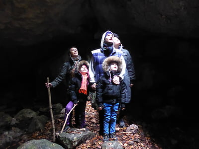 five people looking up inside cave thumbnail