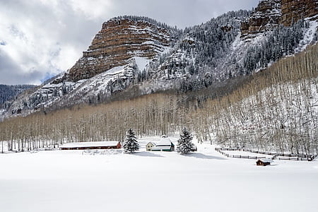 snow capped house near mountain thumbnail