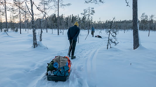 man walking on snow covered road thumbnail