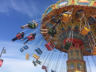three person riding yo-yo ride at daytime thumbnail