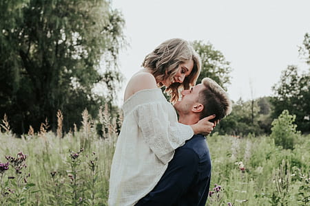 couple smiling while facing each other during daytime thumbnail