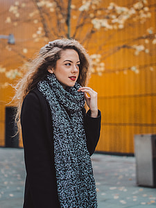 woman in black trench coat and black scarf during daytime thumbnail