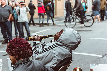 person wearing gray hoodie playing clarinet thumbnail