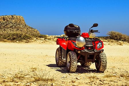 red and black ATV with top box under clear blue sky at daytime thumbnail