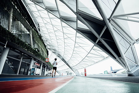 person running on track during daytime thumbnail
