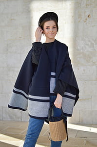 woman touching her hair while holding handbag thumbnail