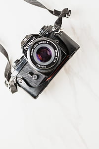 flat-lay photography of black Nikon DSLR camera thumbnail