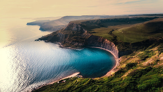 aerial photography of mountains and ocean thumbnail